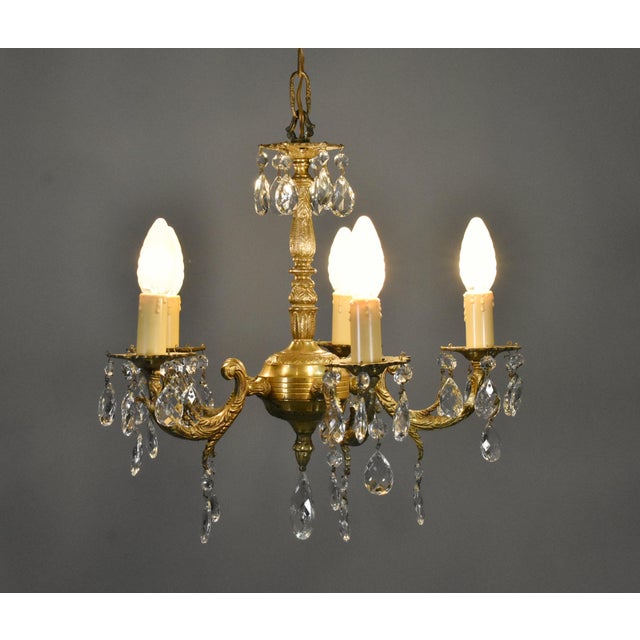An elegant example of French lighting from the early twentieth century, this antique gilt brass and cut glass chandelier...
