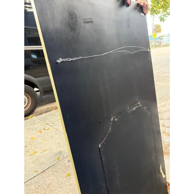 This reproduction antique style trumeau-style large mirror with attached sconces exudes elegance and sophistication. The...