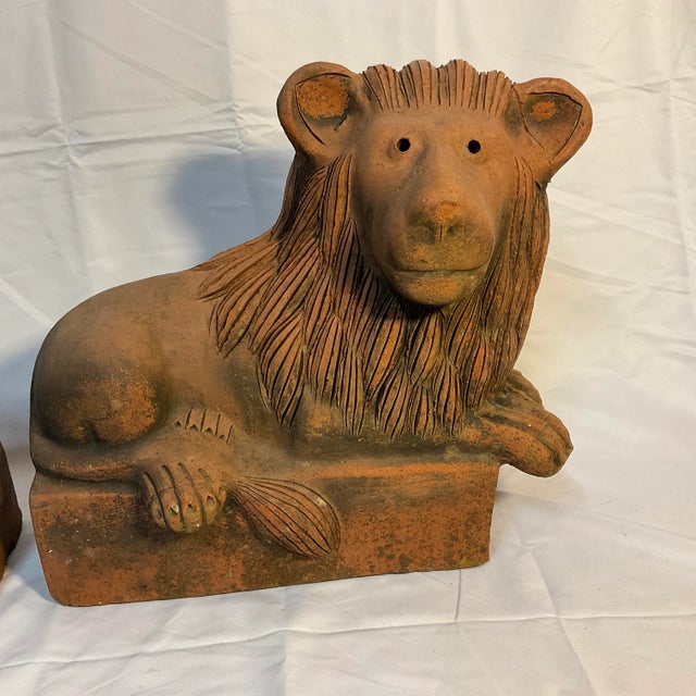 Unique pair of figural unglazed terra cotta lionsl in the manner of celebrated Palm Springs designer Steve Chase. The...