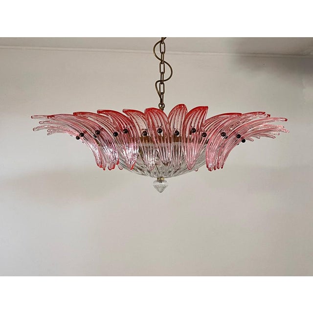 Luxury and genuine murano glass chandelier. Hand made in murano. It made by 36 murano pink glasses in a gold painted metal...