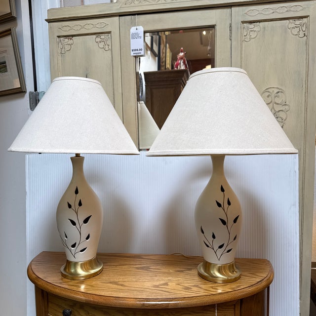 Design Plus Gallery presents a Pair of Ceramic Table Lamps with Leaf Motif Cut Outs. These elegantly rustic and shabby...