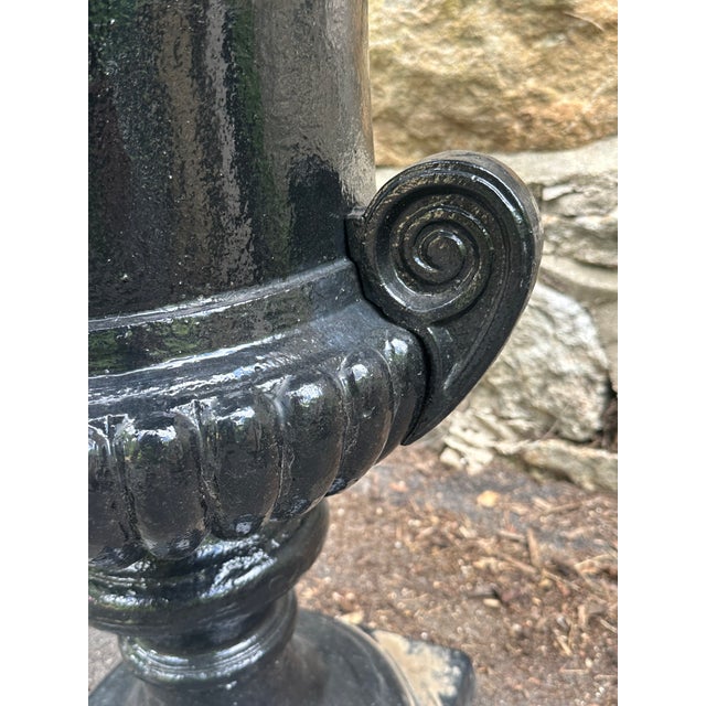 Monumental neoclassical cast iron urn with an unusual smooth rim and scrolled volute handles most likely made by Campania...