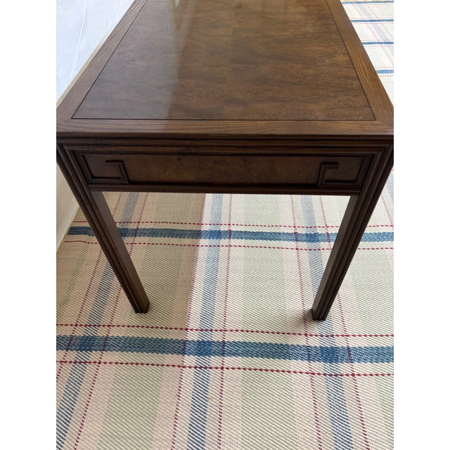 Vintage Chinoiserie-style burl wood writing desk, originally manufactured by Baker Furniture Company, featuring a...