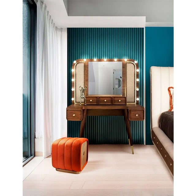 The perfect piece for a classic boudoir. Built in solid wood and displaying polished brass accents and rattan grills, this...
