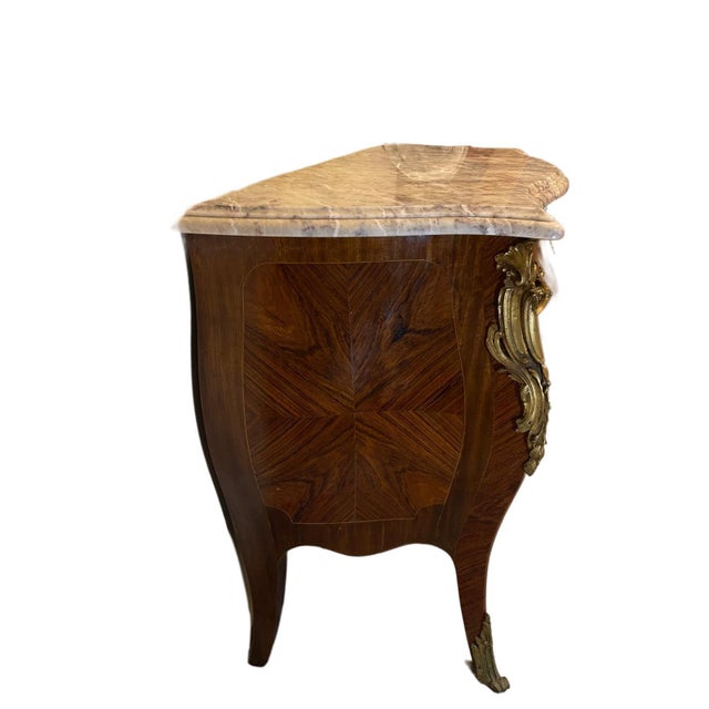 A refined louis xv–style bombé commode crafted in france in the mid-20th century, showcasing traditional french...