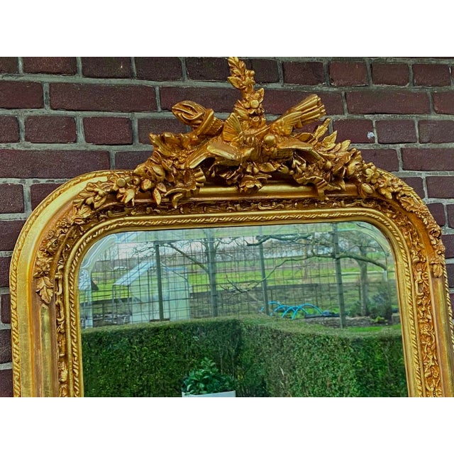 A refined 1980s French Louis XVI–style full-length floor mirror, designed with an elegant vertical silhouette, warm...