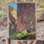 Echoes in The Canyon captures a serene moment within a rocky landscape, where towering cliffs loom over a winding path....