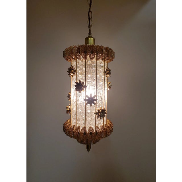 An original and unusual lantern style hanging fixture characterized by open work butterfly wings resulting in a pierced,...