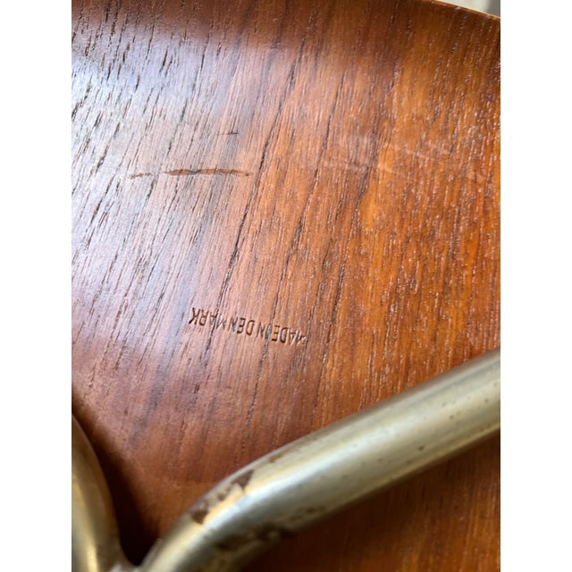 Beautifully refinished Danish teak dining chairs circa 1960's, featuring sculpted bentwood seats and slim chrome legs. In...