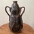 Unusual Art Nouveau earthenware vase of bottle form with large gilded handles. Discover the rustic charm of this...