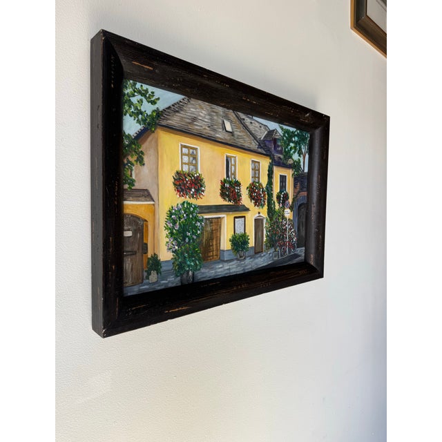 Beautiful vintage impressionist cityscape painting by artist Ann Cohen, capturing the charm of a European-style town...