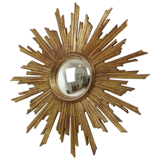 Very rare sunburst mirror gilded with gold leaf, with convex mirror glass, crafted from glass, wood pulp, and resin, by...