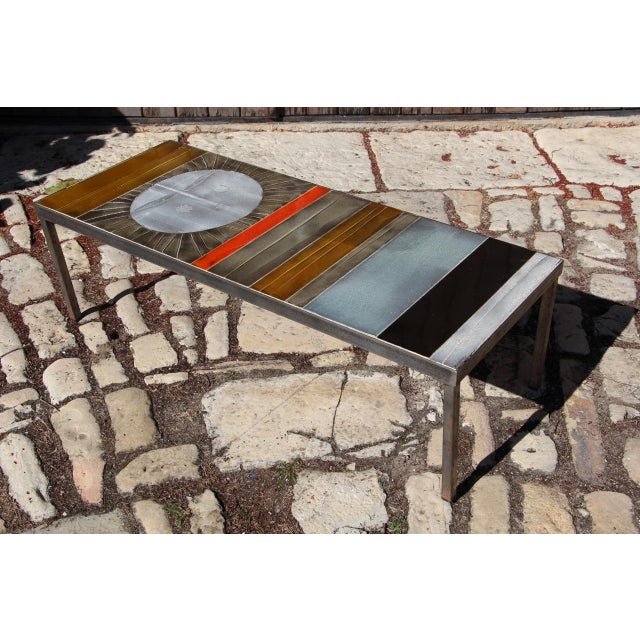"Sun" coffee table - circa 1965 Polychrome glazed ceramic tile top Patinated metal base Signed "R.CAPRON" on the top In...