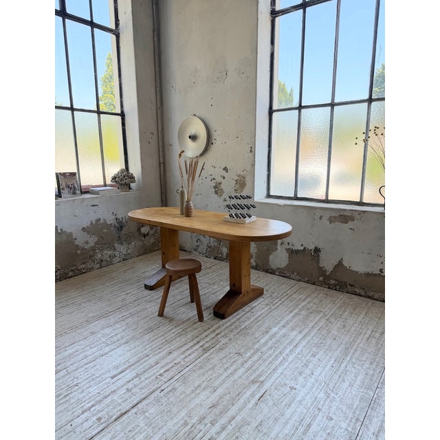 Antique pine table with an oval top and a brutalist-inspired base. we love the beautiful contrast between the curves of...