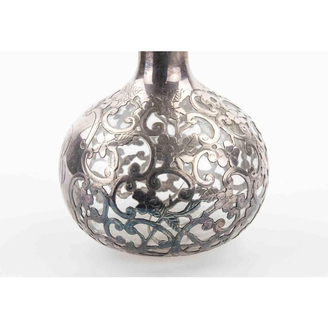 Art Nouveau Sterling Overlay Glass Bottle realized in the early years of 20th Century. Repairs on the glass structure,...