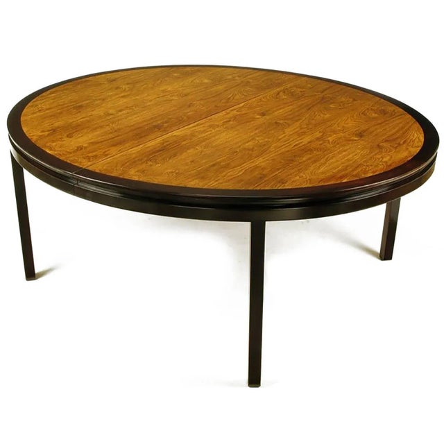 Outstanding custom-made large oval dining table designed by Edward Wormley for Dunbar. Dark stained mahogany border,...