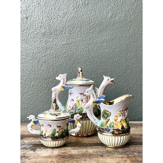 This exquisite 27-piece vintage Capodimonte demitasse service is a stunning tribute to classical Italian artistry and...