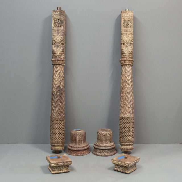 Pair of fantastic antique, three piece, heavily carved teak columns with a round wood base and square capital. Posts are...