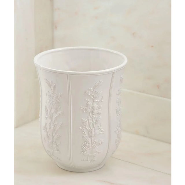 Inspired by 19th century Italian decor, this ceramic wastebasket is beautifully decorated with a relief floral pattern....