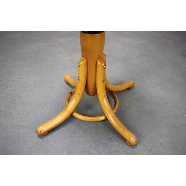 A distinctive vintage adjustable piano stool manufactured by Tatra Nábytek, závod Martin, in Czechoslovakia around 1960....