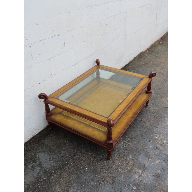 This gorgeous Coffee Table is made out of wood, solid wood, leather, and glass. The Table was made by Maitland Smith, an...