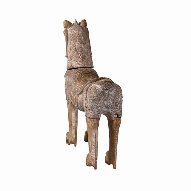 Vintage wooden sculpture Qulin (or Kylin), a mythical Chinese creature often described as a dragon-horse. It features the...