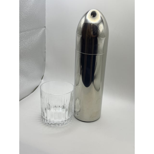 Striking vintage bullet-form cocktail shaker crafted in polished stainless steel. Featuring a tall cylindrical body and...