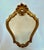 Imported from Belgium. Ornate rococo style gilded mirror. Classic gold finish adapts to any decor. The diminutive size...