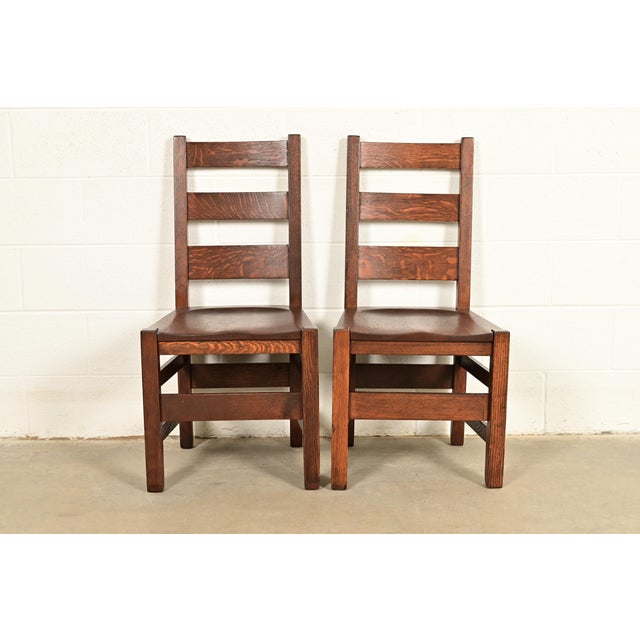 An exceptional pair of antique Mission or Arts & Crafts period solid quarter sawn oak ladder back side chairs or dining...