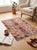 A hand-knotted area rug in the Mamluk design, woven on a soft ivory ground with madder red, sage green, gold and indigo....