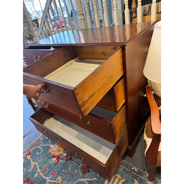 This is an antique Georgian style English chest of drawers. It is mahogany with inlay. It has 5 drawers. The top two...