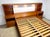 A spectacular circa 1970’s Torring Mobelfabrik Danish Modern queen size teak platform bed set with attached storage...