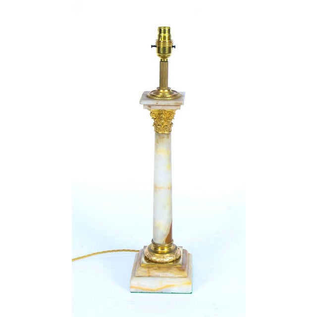 This is a splendid antique late Victorian ormolu mounted onyx Corinthian column table lamp now converted to electricity,...
