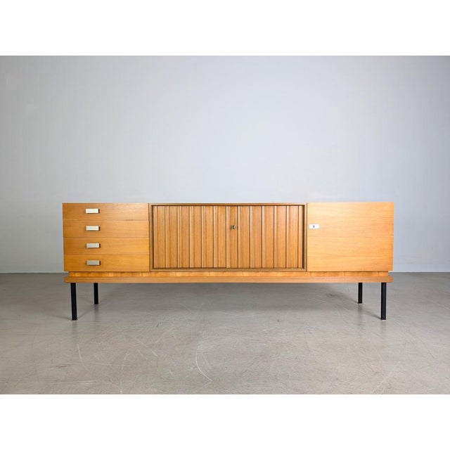 A beautiful and extremely rare vintage sideboard by Famöla Möbel from the 1950s. with four drawers and three spacious...