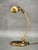 An elegant and highly functional adjustable german table lamp from the 1960s, executed primarily in brass with metal and...