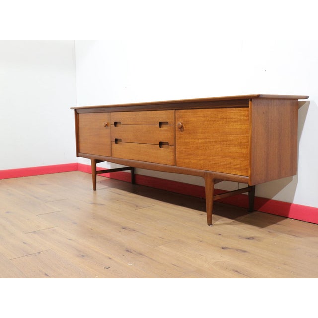 Discover timeless elegance with our exquisite beautiful sideboard by British firm Younger designed by John Herbert in the...