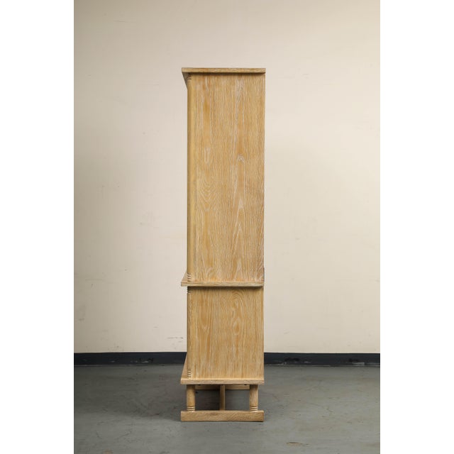 Inspired by vintage 1930s Art Deco designs, the Crate x Athena "Honore" tall cerused oak cabinet features subtle ridge...