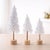 Create a cozy winter wonderland in any room with this charming set of flocked pine tabletop trees. Featuring snowy white...