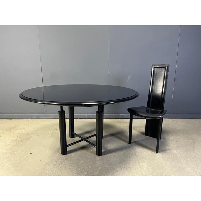 Rare post modern dining table with a black metal frame and a black glass top. Beautiful post modern design. Good overall...