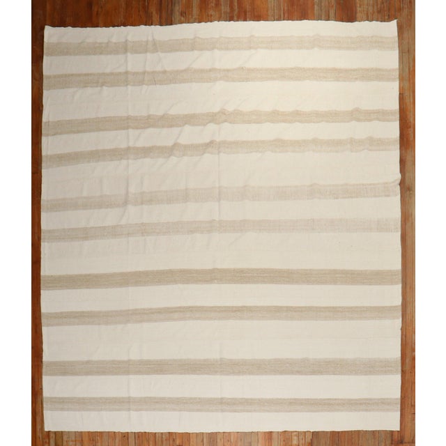 Room- Square size Turkish Kilim in ivory and brown made from recycled cotton and goat hair material giving it an old...