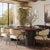 The Marlow Oval Dining Table exudes sophistication with its deep brown wood top and sleek black base. The rich, dark...