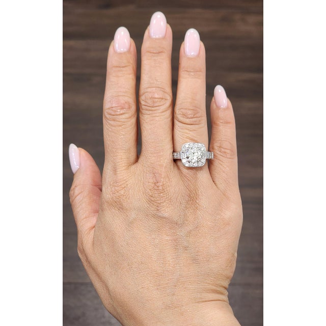 A captivating 2.0-carat diamond commands attention at the center, showcasing a white hue with VS1/VS2 clarity and a J/K...