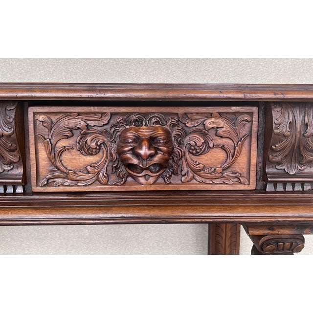 20th century console carved table Renaissance made of solid walnut wood It features carvings of mythological animals and...