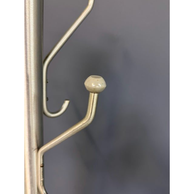 A striking mid-century modern coat and hat rack in brushed satin aluminum, featuring an asymmetrical branch-form...