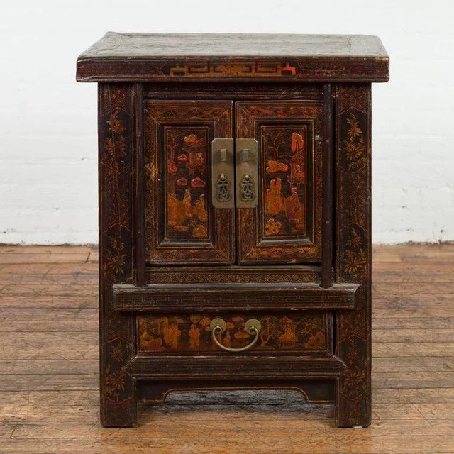 A Chinese Qing Dynasty period bedside cabinet from the 19th century with original lacquer, pair of petite double doors,...