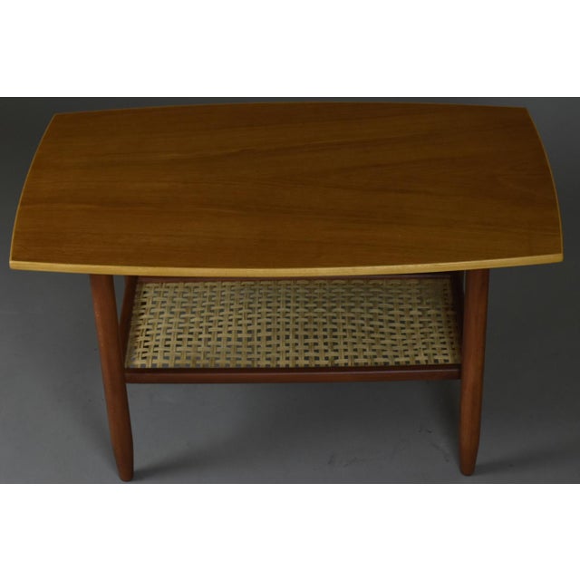 An elegant Scandinavian modern coffee table dating back to the 1960s, meticulously restored in our atelier. The tabletop,...