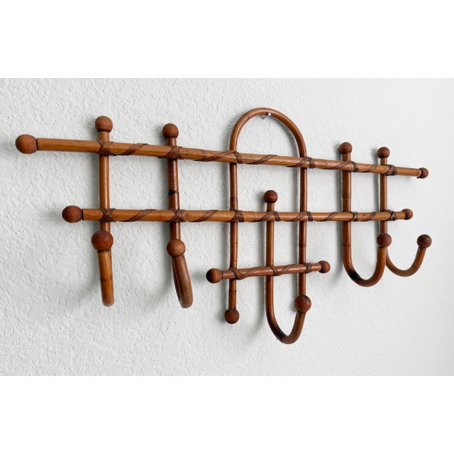 1950s Italian bamboo and cane wall hooks, featuring five hooks with wood ball finials, wrapped cane at the attachment...