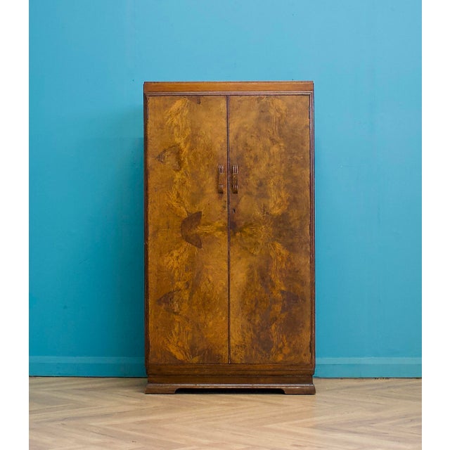 A stylish 1930s Art Deco compact wardrobe by Palatal Furniture, featuring beautifully figured burr walnut veneer to the...