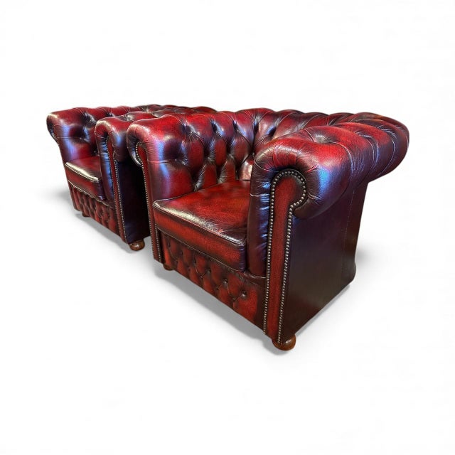 Genuine leather with deep button tufting. Traditional Chesterfield with rolled arms and studded detailing Two armchairs...