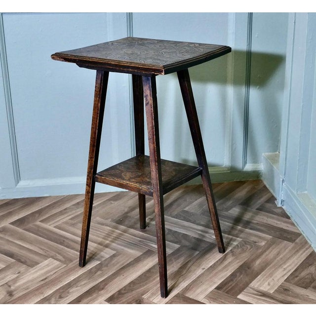 An Edwardian Carved Oak Etagere or Occasional Table This useful little table has two tiers, the top is square with a...